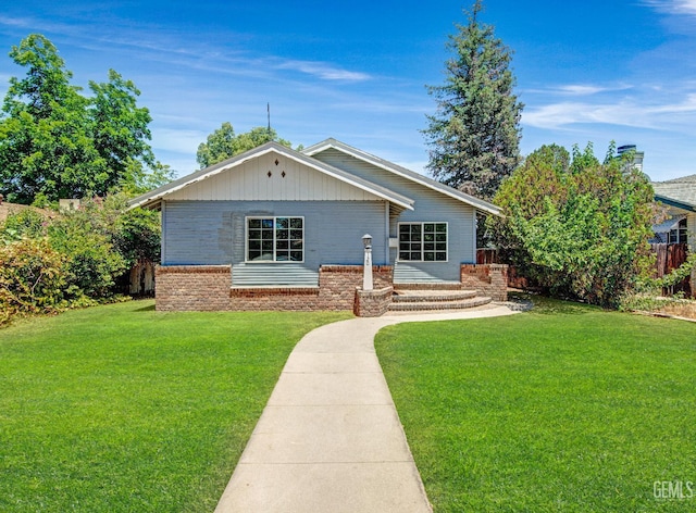 120 Pacific St, Bakersfield, CA 93305 - view of front of home featuring a front lawn and brick siding