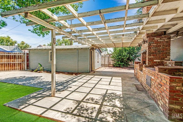 120 Pacific St, Bakersfield, CA 93305 - fenced backyard featuring a patio, a pergola, a fireplace, and an outbuilding