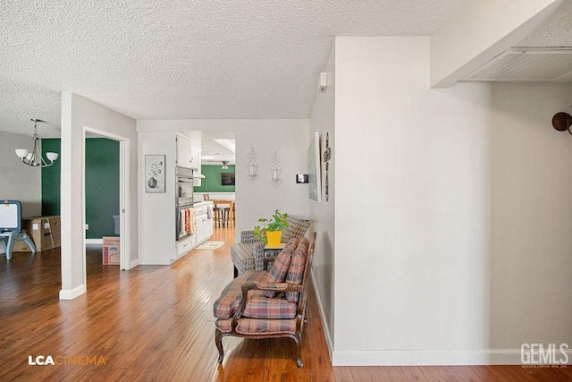 1800 Weyburn Way, Bakersfield, CA 93309 - hall with wood finished floors, a chandelier, and a textured ceiling