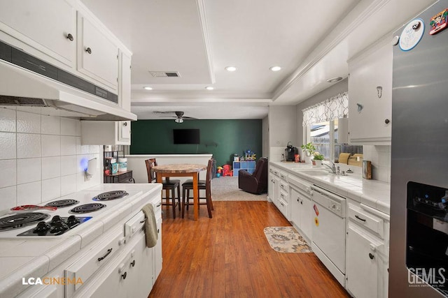1800 Weyburn Way, Bakersfield, CA 93309 - kitchen with tile counters, white appliances, under cabinet range hood, white cabinets, and recessed lighting