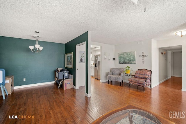 1800 Weyburn Way, Bakersfield, CA 93309 - living room with a textured ceiling, wood finished floors, and a chandelier