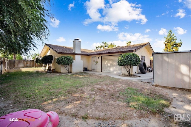 1800 Weyburn Way, Bakersfield, CA 93309 - rear view of property with a garage, a fenced backyard, a chimney, driveway, and stucco siding