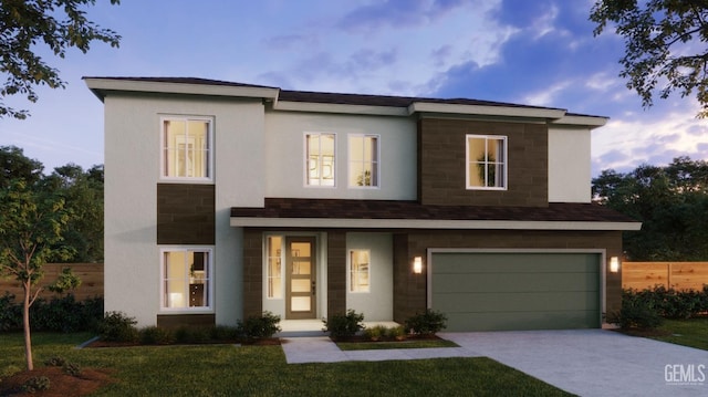 view of front of house with a yard and a garage