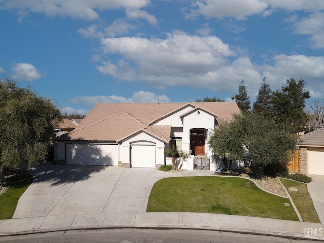 view of front of property with a garage and a front yard