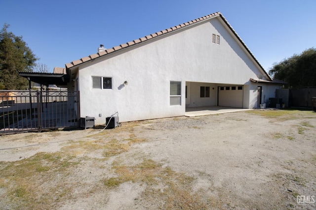 back of property with a garage