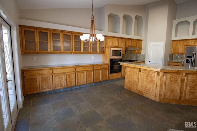 kitchen featuring a notable chandelier, decorative backsplash, hanging light fixtures, stainless steel appliances, and high vaulted ceiling