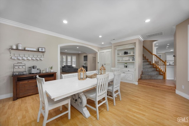 214 Driver Rd, Bakersfield, CA 93314 - dining room featuring arched walkways, light wood-type flooring, recessed lighting, crown molding, and baseboards