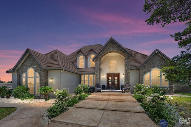 214 Driver Rd, Bakersfield, CA 93314 - view of front of house featuring stucco siding, stone siding, a tile roof, and french doors