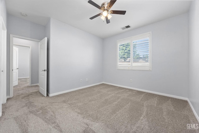 unfurnished bedroom featuring ceiling fan, visible vents, baseboards, and carpet
