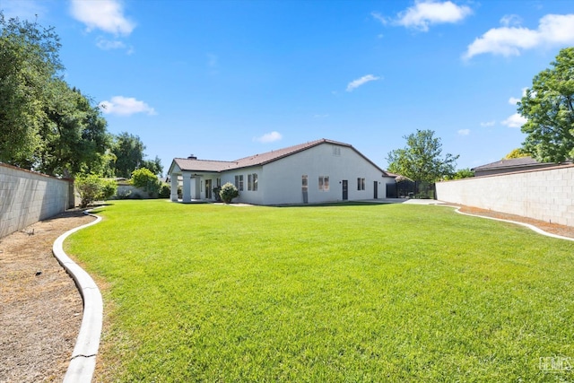 view of yard with a fenced backyard