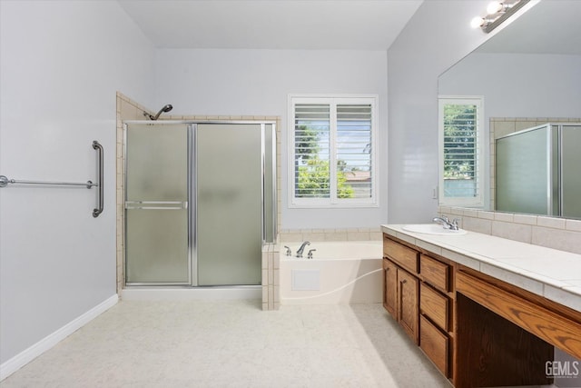full bathroom with a shower stall, plenty of natural light, and vanity