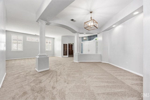 interior space with visible vents, baseboards, decorative columns, and carpet floors