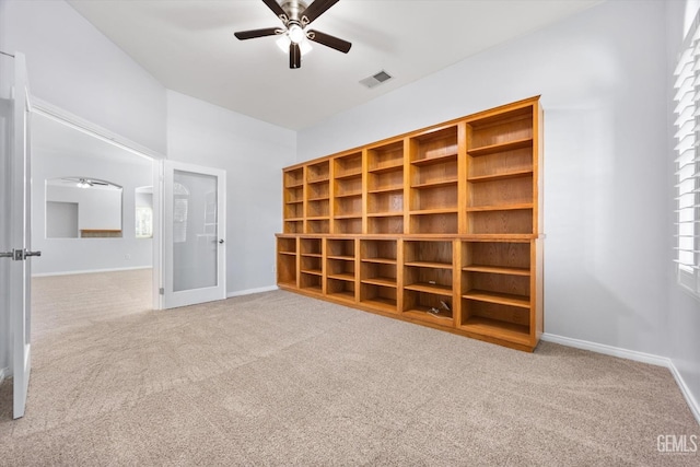 carpeted spare room with ceiling fan, baseboards, and visible vents