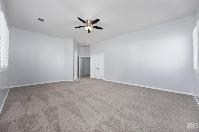unfurnished bedroom with visible vents, baseboards, ceiling fan, and carpet