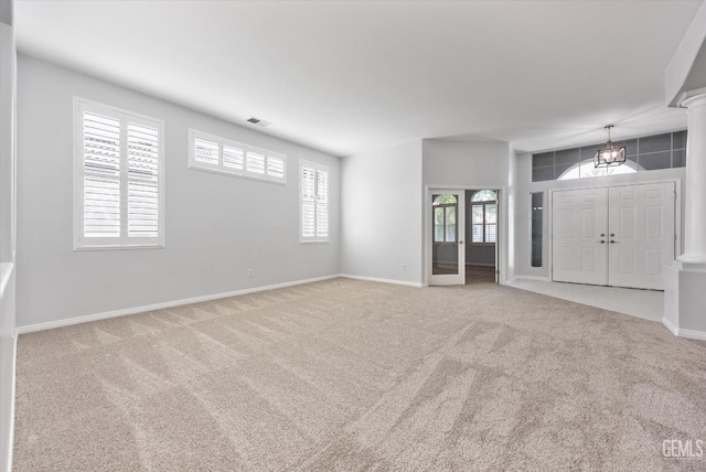 unfurnished living room with baseboards, visible vents, and carpet floors