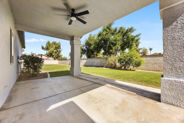 view of patio with a fenced backyard and a ceiling fan