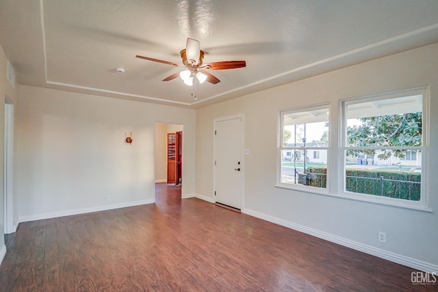 empty room with dark hardwood / wood-style floors and ceiling fan