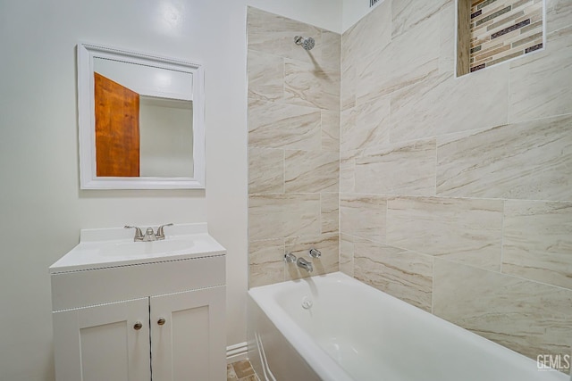 bathroom with vanity and tiled shower / bath