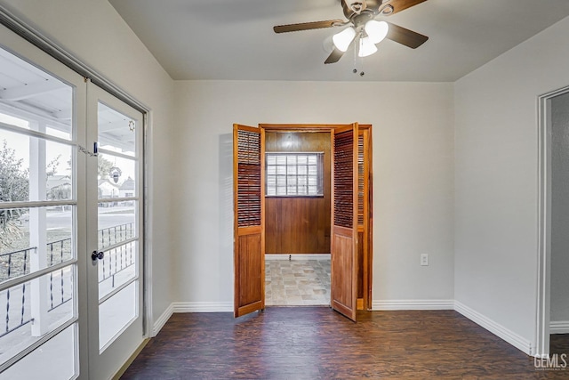 interior space featuring dark wood-type flooring, ceiling fan, access to exterior, and multiple windows