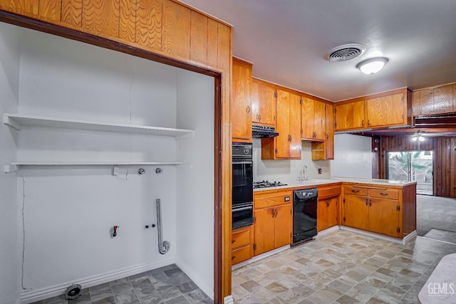 kitchen with kitchen peninsula, sink, and black appliances