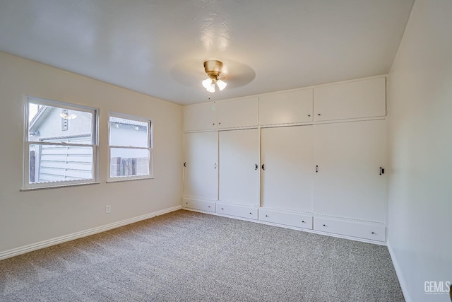 unfurnished bedroom featuring a closet, ceiling fan, and carpet