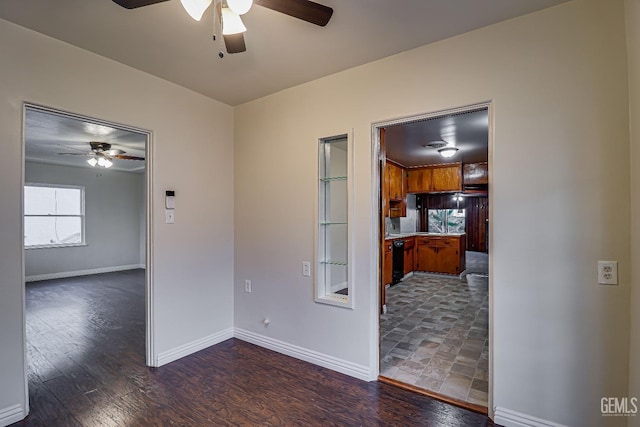 spare room with dark hardwood / wood-style floors and ceiling fan