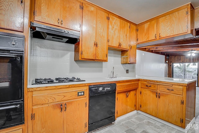 kitchen featuring range hood, sink, kitchen peninsula, and black appliances