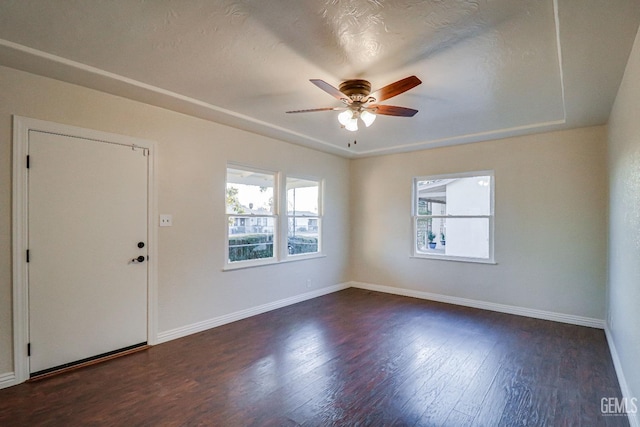 interior space featuring dark wood-type flooring and ceiling fan