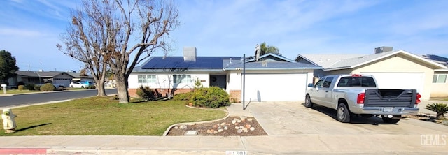 ranch-style home featuring solar panels, a garage, and a front yard