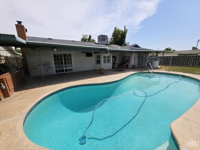 1301 5th Pl, Delano, CA 93215 - view of swimming pool with a patio, central air condition unit, and grilling area
