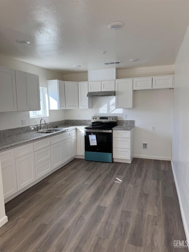 kitchen featuring stainless steel electric range oven, visible vents, dark wood-style flooring, and a sink