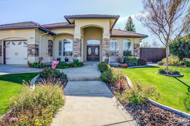 mediterranean / spanish home featuring a garage, french doors, and a front lawn