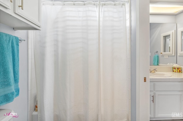 bathroom featuring shower / bath combination with curtain and vanity