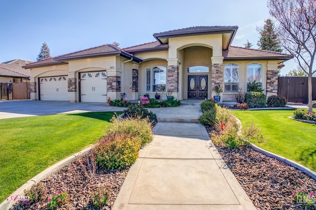 mediterranean / spanish house featuring a garage and a front lawn