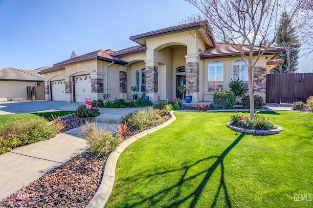 mediterranean / spanish house featuring a garage and a front lawn