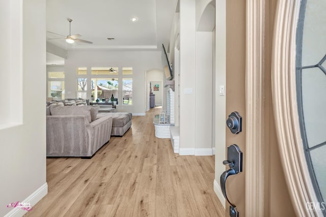 living room with ceiling fan and light hardwood / wood-style floors