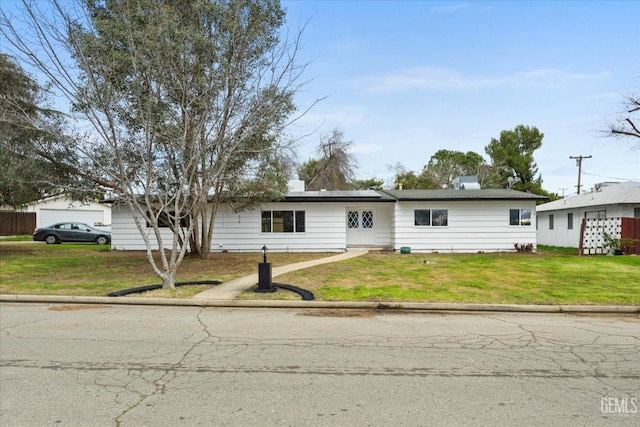 ranch-style home featuring a front yard