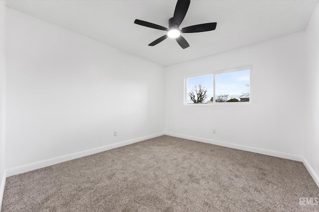 unfurnished room with ceiling fan and carpet