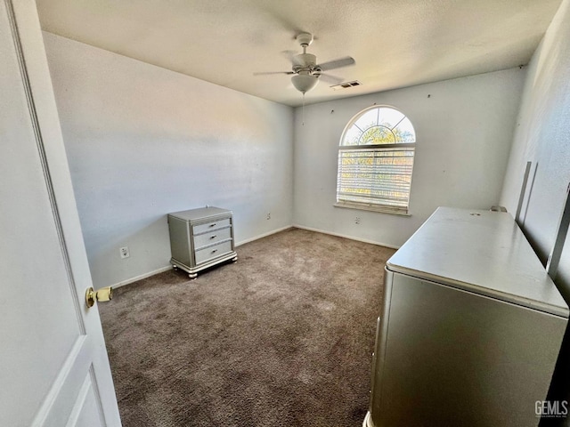 interior space featuring a ceiling fan, carpet, visible vents, and baseboards