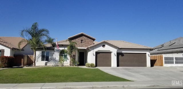 view of front of home with a front yard and a garage