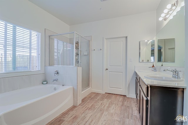 bathroom featuring separate shower and tub, vanity, and wood-type flooring