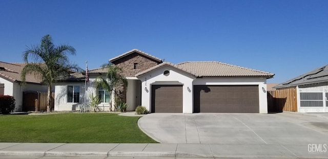 view of front of property with a front yard and a garage