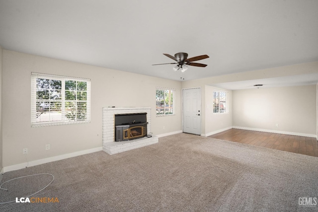 2620 Connie Ave, Bakersfield, CA 93304 - unfurnished living room featuring ceiling fan, a wood stove, baseboards, and carpet