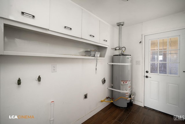2620 Connie Ave, Bakersfield, CA 93304 - clothes washing area with cabinet space, electric dryer hookup, strapped water heater, baseboards, and dark wood-style flooring
