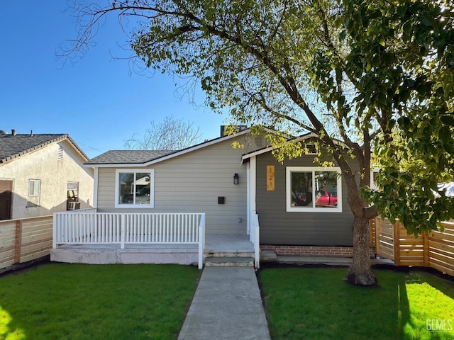 view of front of home featuring covered porch and a front yard