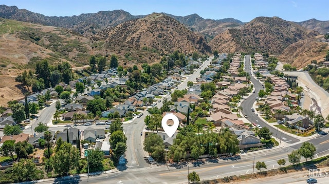 drone / aerial view featuring a residential view and a mountain view