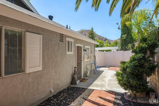 exterior space with a fenced backyard and a mountain view