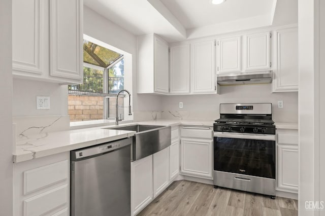 kitchen featuring under cabinet range hood, appliances with stainless steel finishes, and white cabinets