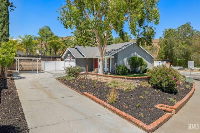 ranch-style house featuring driveway and fence