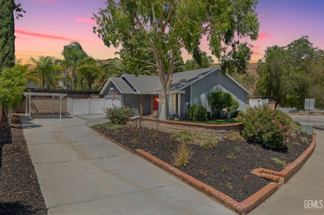 ranch-style house featuring a garage, a gate, and fence